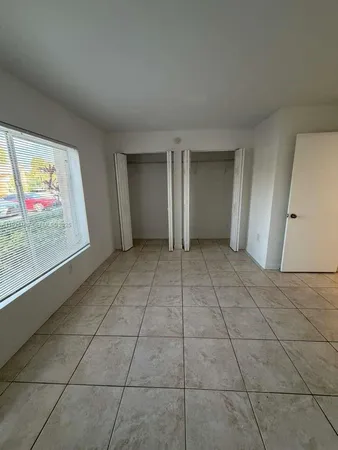 a view of an empty room with glass door