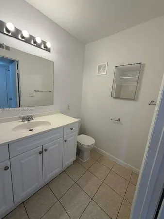 a spacious bathroom with a double vanity sink mirror and toilet