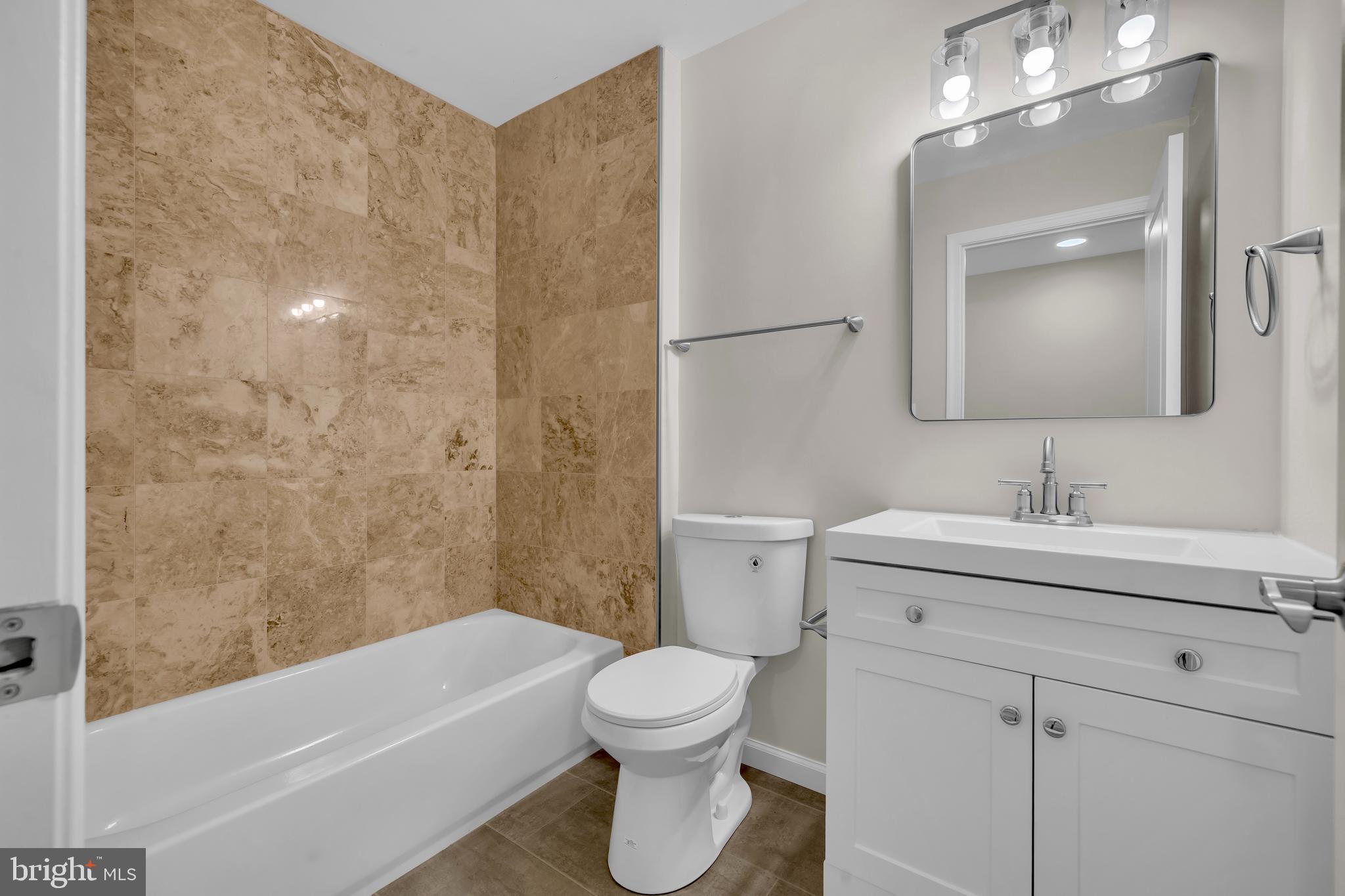 1626 Hazel Street Curtis Bay, MD 21226 - Photo 16 of 24 a bathroom with a sink a toilet and shower