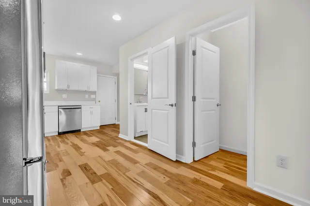 a view of an empty room with a fireplace and a cabinet