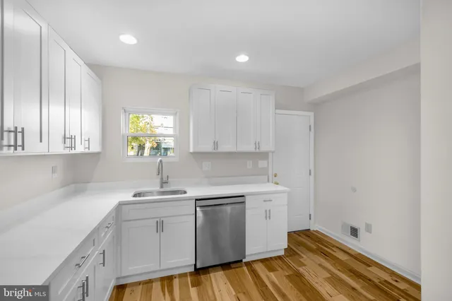 a kitchen with a sink cabinets and window