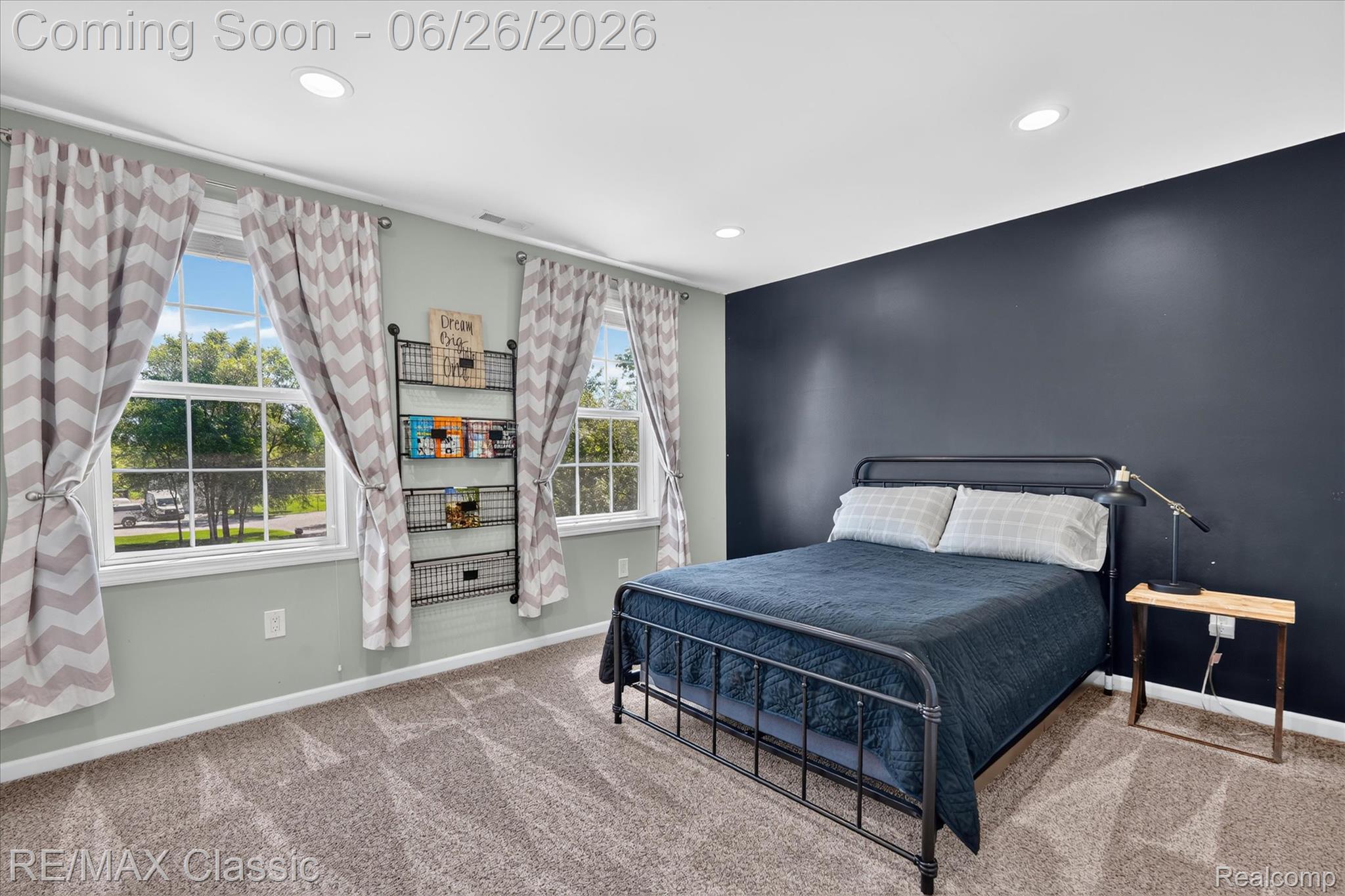 3205 North Milford Road Highland, MI 48357 - Photo 27 of 53 Room featuring two large windows, recessed ceiling lighting, a dark accent wall, and neutral carpet flooring