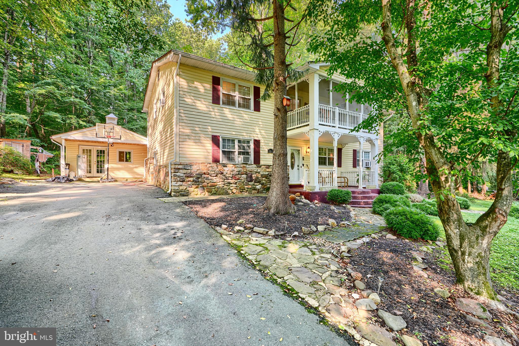 6065 Poplar Road St. Leonard, MD 20685 - Photo 1 of 50 a front view of a house with a yard and trees