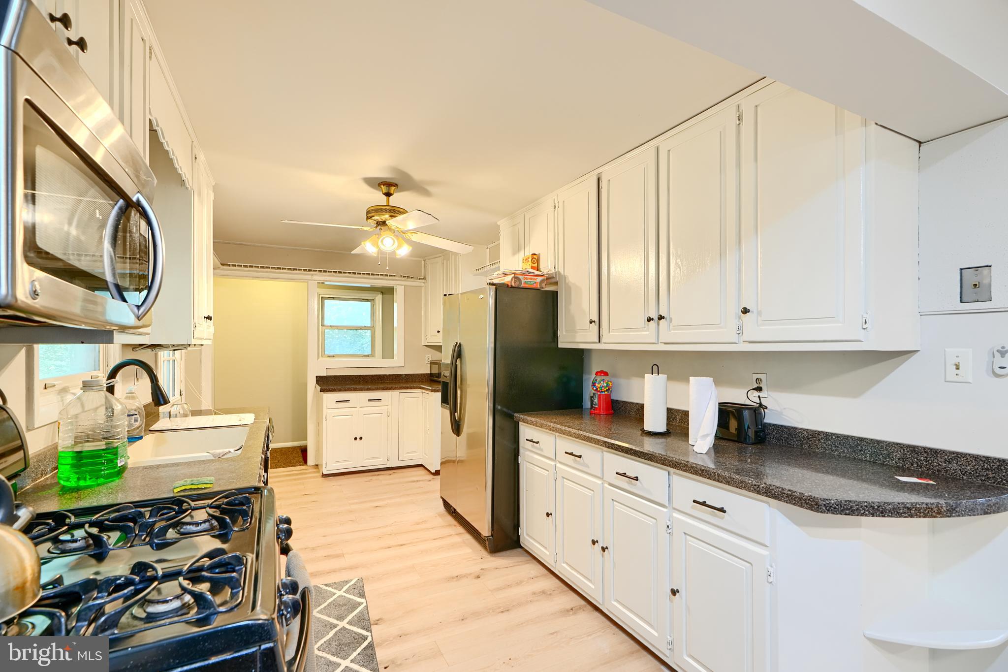6065 Poplar Road St. Leonard, MD 20685 - Photo 15 of 50 a kitchen with stainless steel appliances granite countertop a sink stove and cabinets