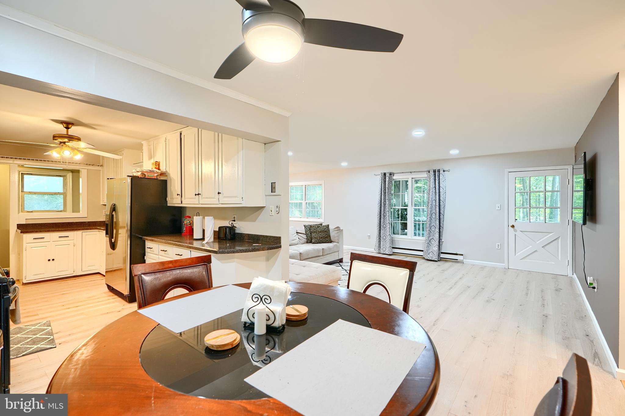 6065 Poplar Road St. Leonard, MD 20685 - Photo 17 of 50 a living room with furniture kitchen view and a large window