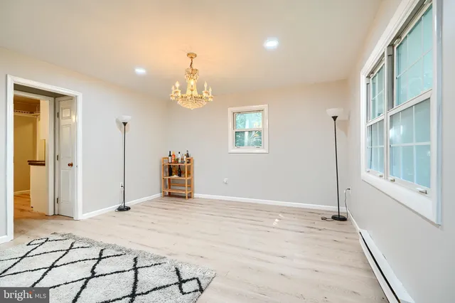 a view of a livingroom with wooden floor and a large window