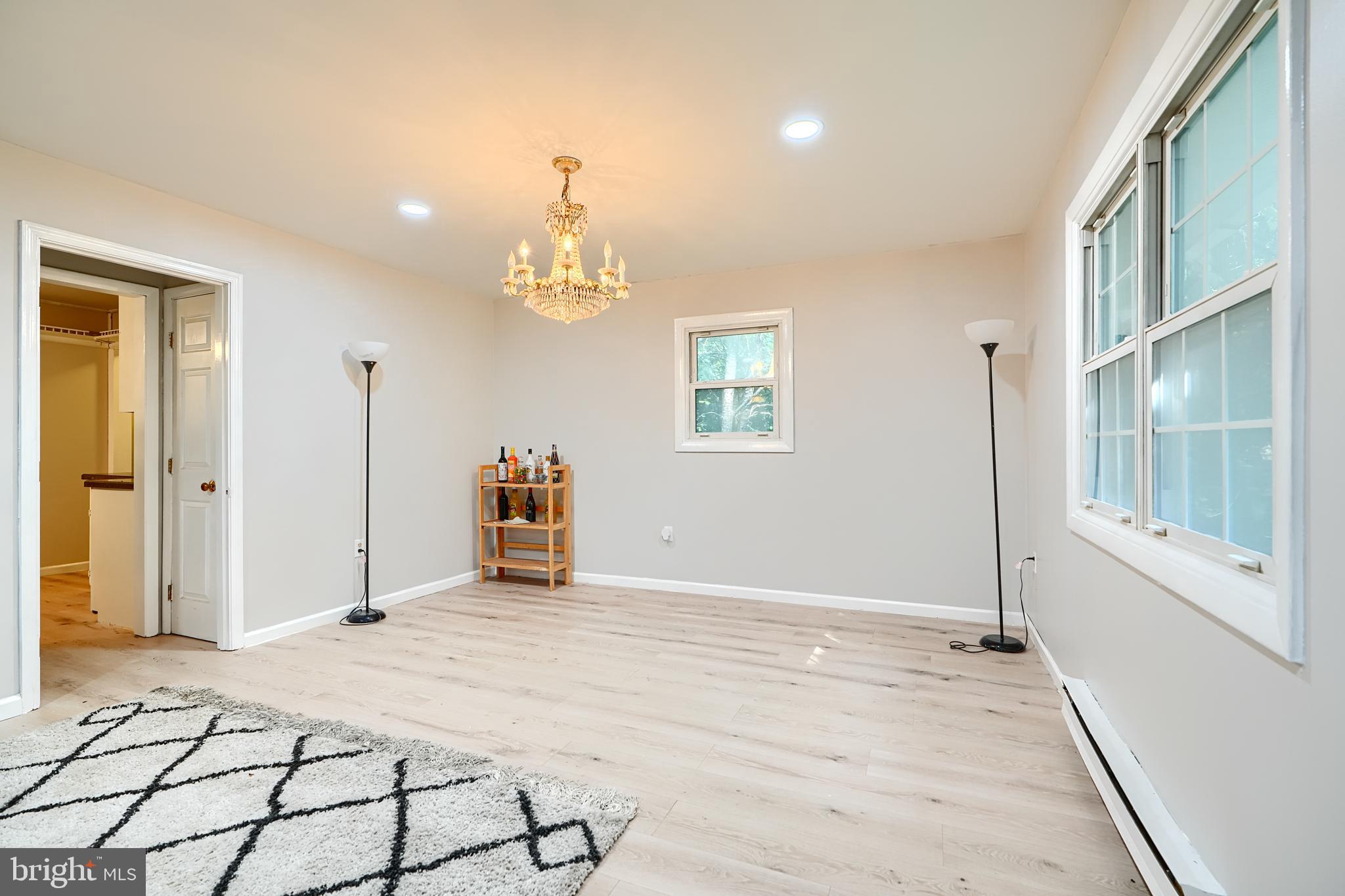 6065 Poplar Road St. Leonard, MD 20685 - Photo 21 of 50 a view of a livingroom with wooden floor and a large window