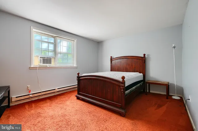 a bedroom with a bed and window