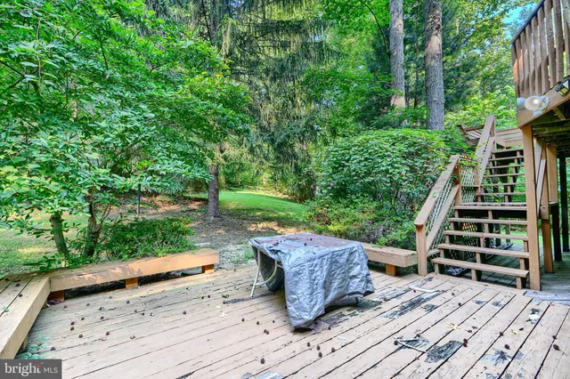 a wooden bench sitting next to a yard