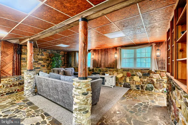 a living room with furniture and a ceiling fan