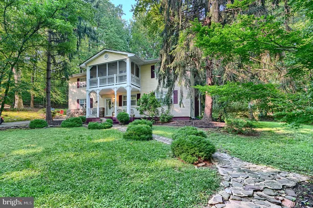 a view of a house with a yard and sitting area