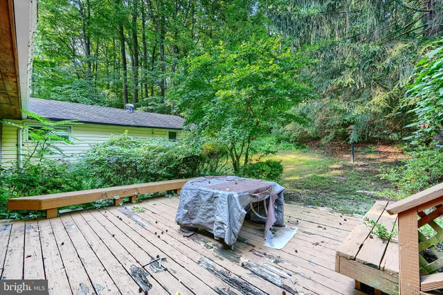 a view of a wooden deck with a yard