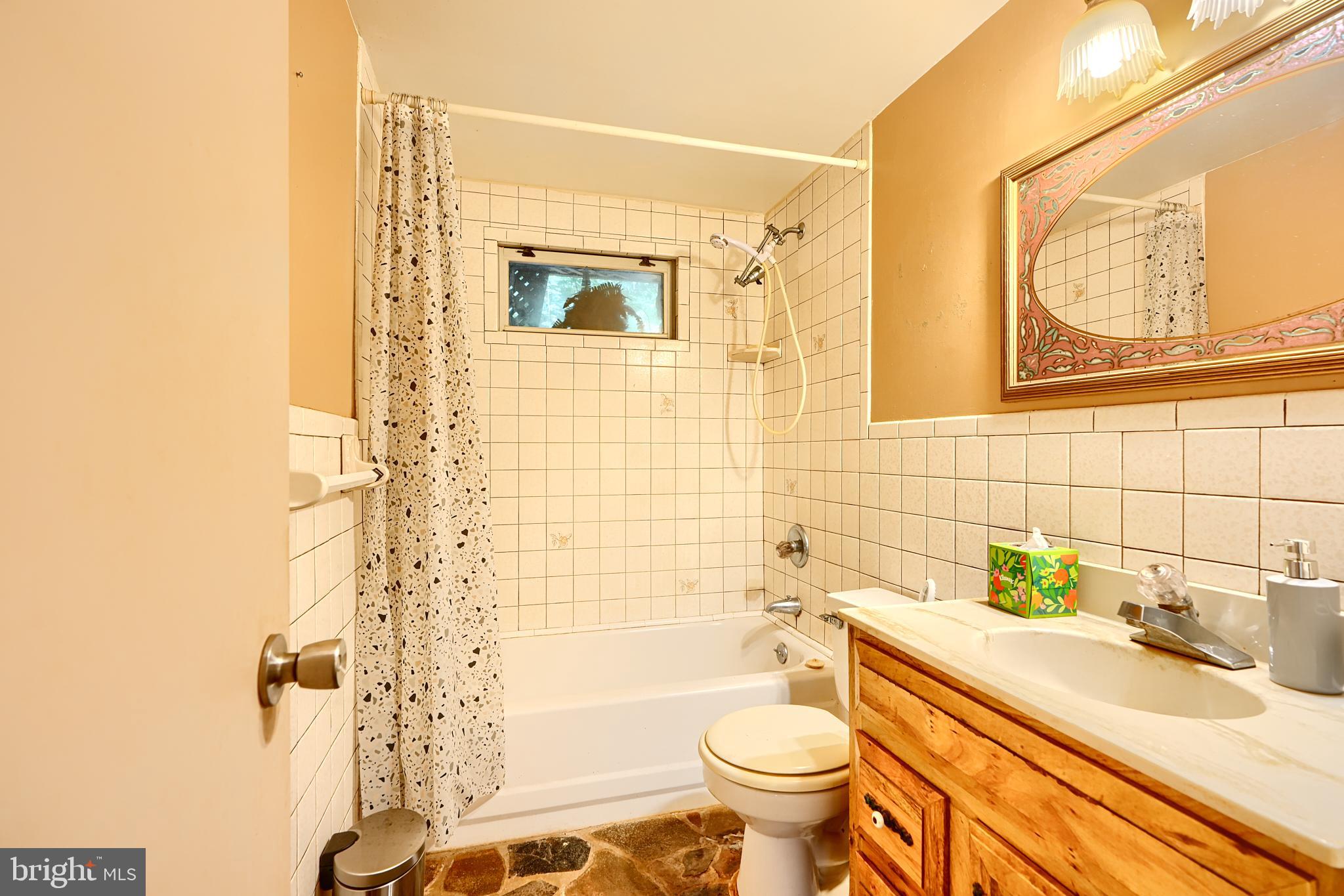 6065 Poplar Road St. Leonard, MD 20685 - Photo 7 of 50 a bathroom with a sink toilet and shower