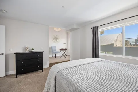 a bedroom with a bed and a chair