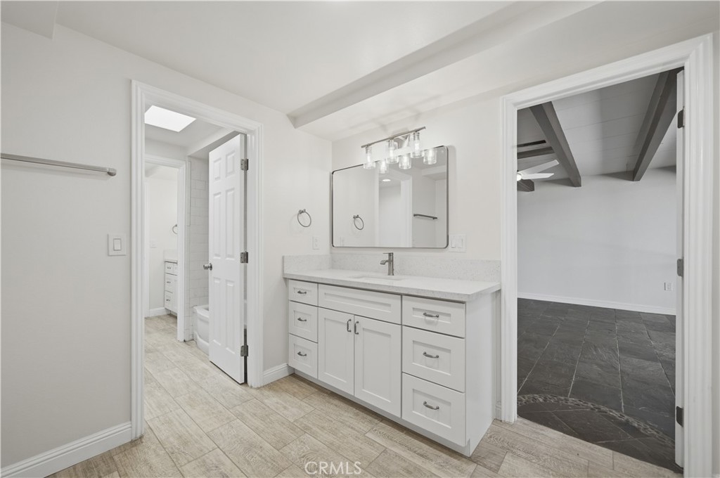 600 Gibbel Road Hemet, CA 92543 - Photo 12 of 28 1 bath vanity fully remodeled and all new w plank tile flooring, self closing cabinets, custom faucet fixtures, mirror and custom lighting.