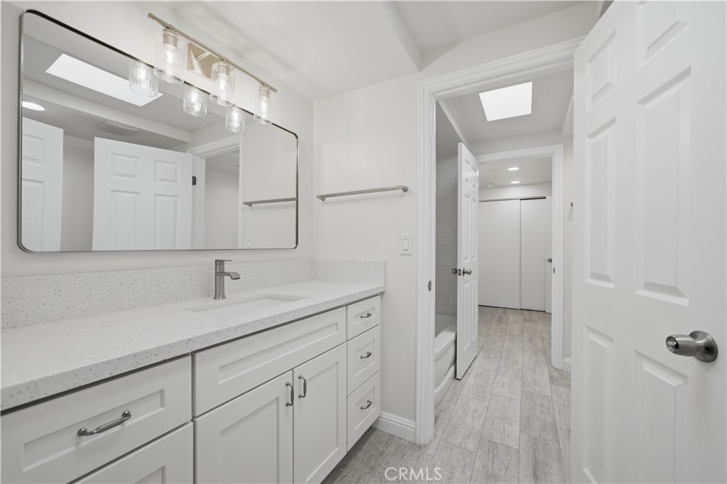 600 Gibbel Road Hemet, CA 92543 - Photo 20 of 28 Vanity area #2 freshly painted w new self closing drawer/cabinet vanity, sink fixtures, mirror and custom lighting w door leading to separate tub/shower area.