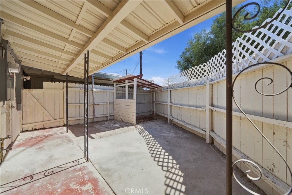 600 Gibbel Road Hemet, CA 92543 - Photo 21 of 28 Covered and enclosed patio area w gate at the left leading to garage space.