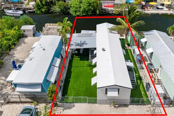 an aerial view of house with yard swimming pool and outdoor seating