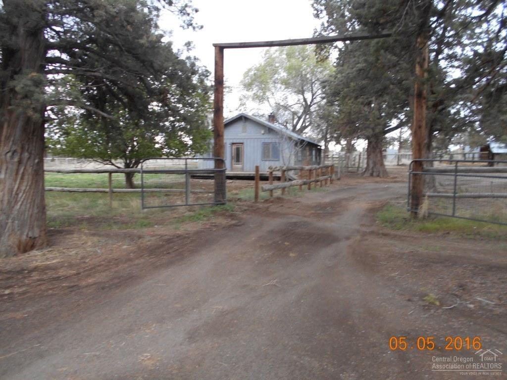 23045 Alfalfa Market Road Bend, OR 97701 - Photo 2 of 12 a view of a yard with a large tree