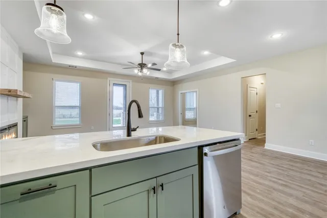 a kitchen with a sink and chandelier
