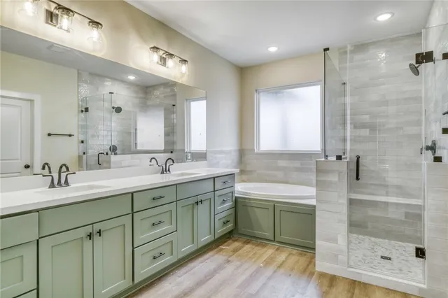 a bathroom with a double vanity sink mirror and shower