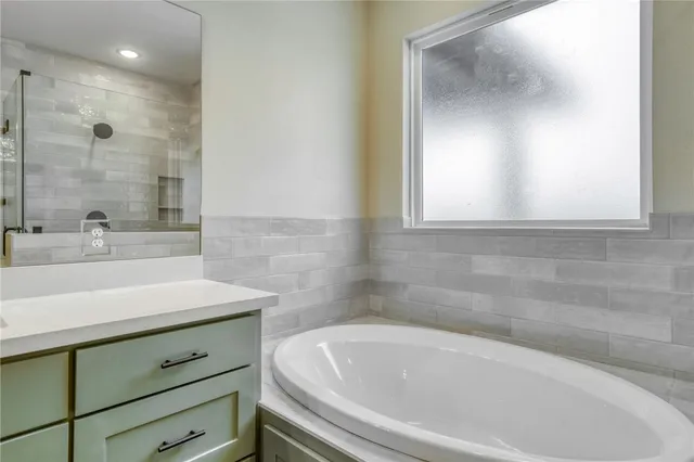 a bathroom with a bathtub and a sink