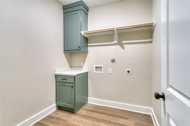 a view of a hallway with wooden floor and closet