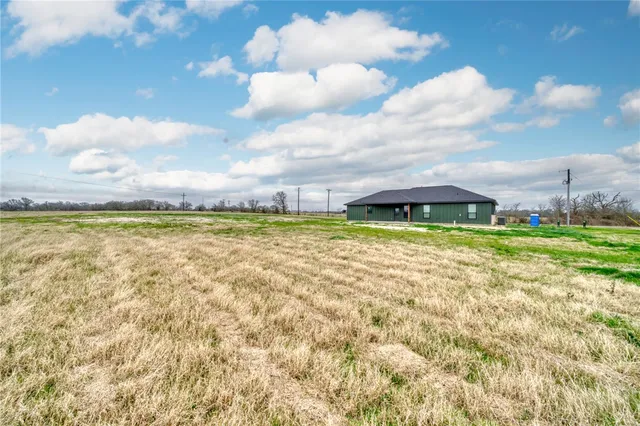 a view of a large body of water with a building in the background