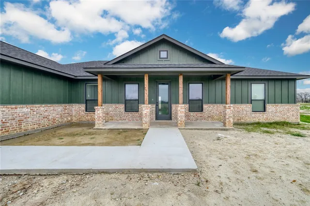 a view of a house with swimming pool and sitting area