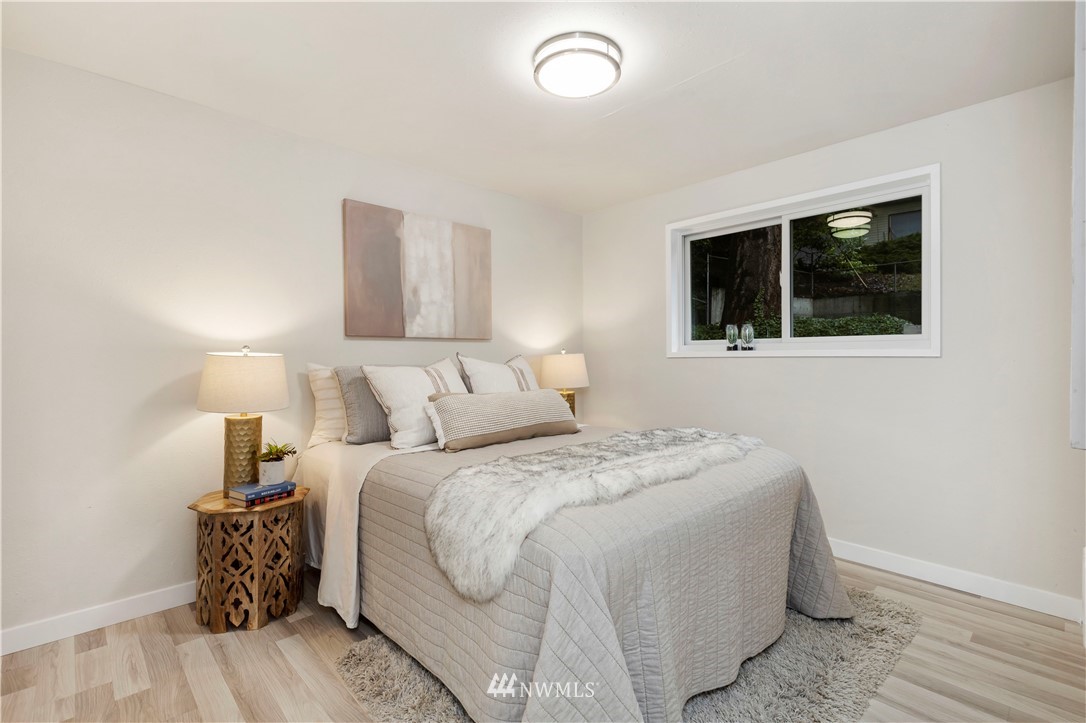 3012 Southwest 102nd Street Seattle, WA 98146 - Photo 22 of 32 a bedroom with a large bed and a window