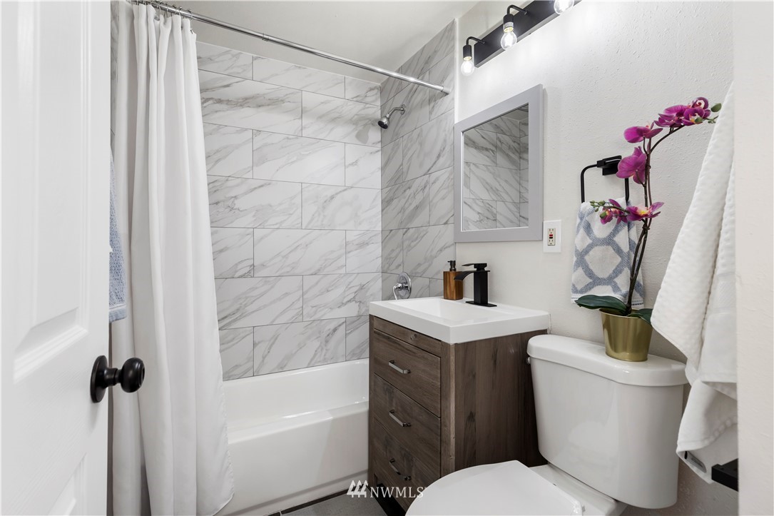 3012 Southwest 102nd Street Seattle, WA 98146 - Photo 23 of 32 a bathroom with a sink toilet and shower