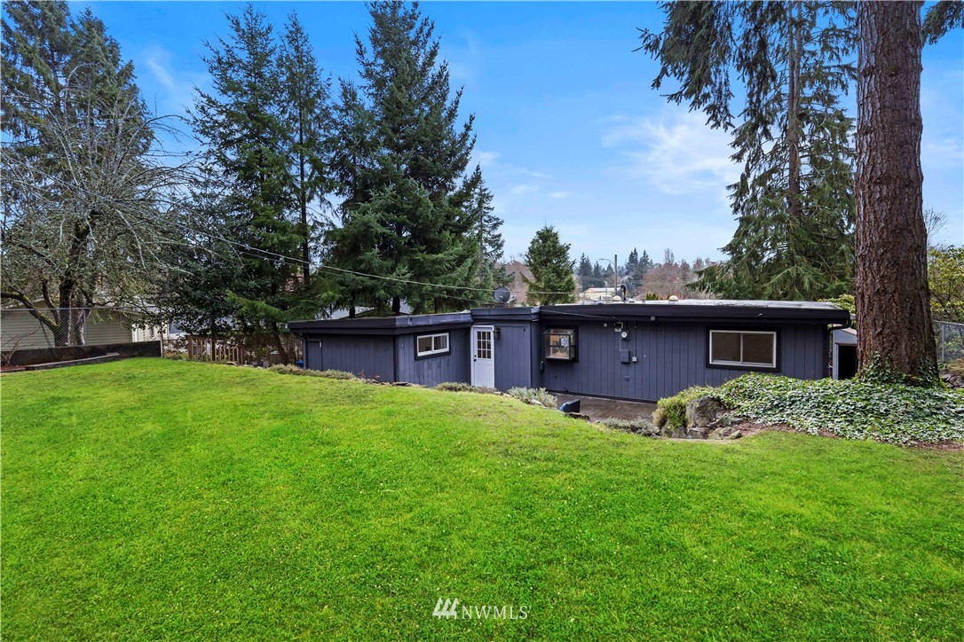 3012 Southwest 102nd Street Seattle, WA 98146 - Photo 30 of 32 a view of a yard in front of a house with large trees