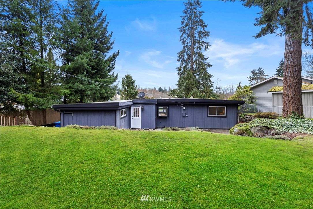 3012 Southwest 102nd Street Seattle, WA 98146 - Photo 31 of 32 a view of a yard in front of a house with a large tree