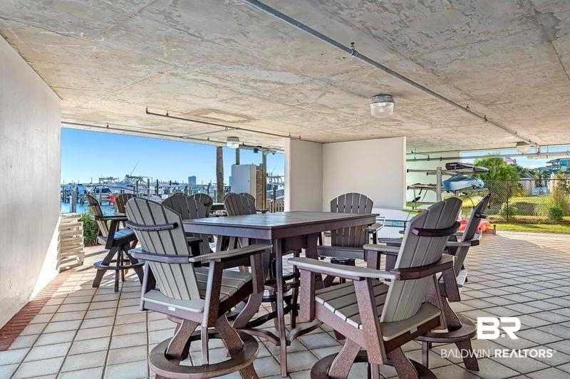 27800 Canal Road, Unit 411 Orange Beach, AL 36561 - Photo 40 of 49 Covered outdoor patio with a tiled floor and concrete ceiling