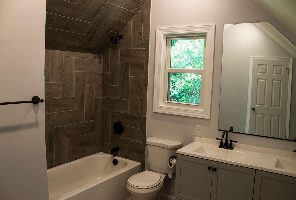 4438 Windsor Spring Road Hephzibah, GA 30815 - Photo 20 of 23 The master en suite bathroom has a double vanity, fully-tiled bath/shower, and a linen closet.