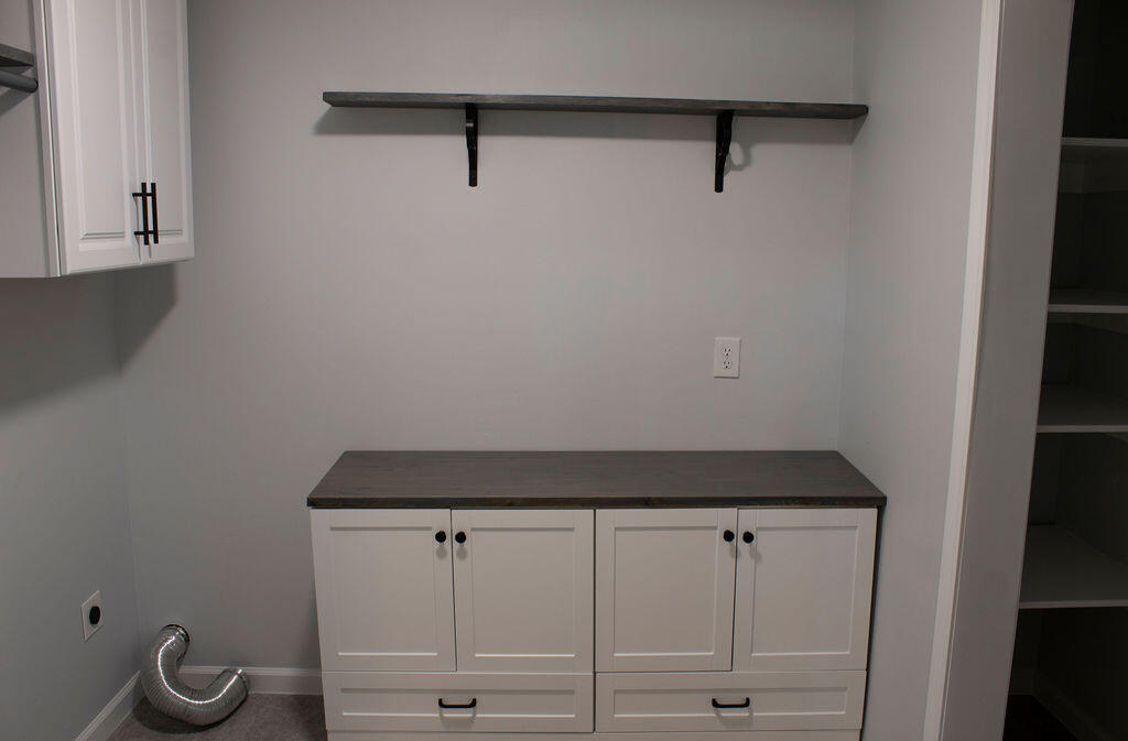 4438 Windsor Spring Road Hephzibah, GA 30815 - Photo 7 of 23 The laundry room boasts plenty of counter space and cabinets for storage.