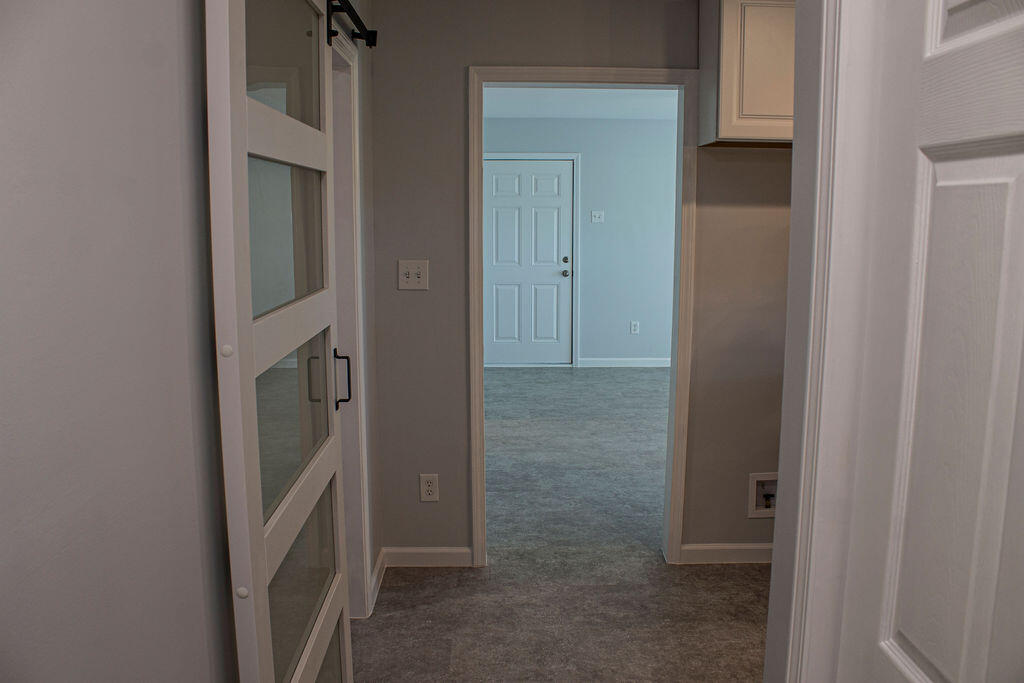 4438 Windsor Spring Road Hephzibah, GA 30815 - Photo 10 of 23 This is the view from the downstairs hallway to the great room/flex room entrance.