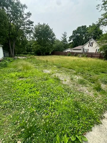 a view of yard with swimming pool and green space