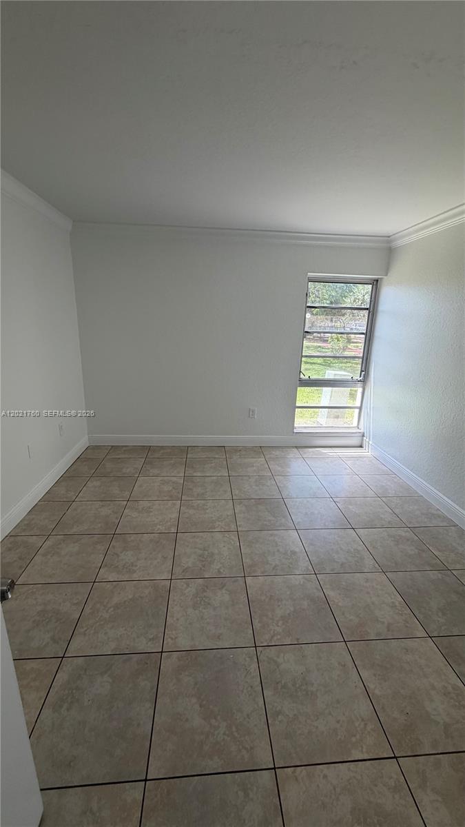 3901 Southwest 109th Avenue, Unit 4 Miami, FL 33165 - Photo 9 of 15 a view of an empty room with a window