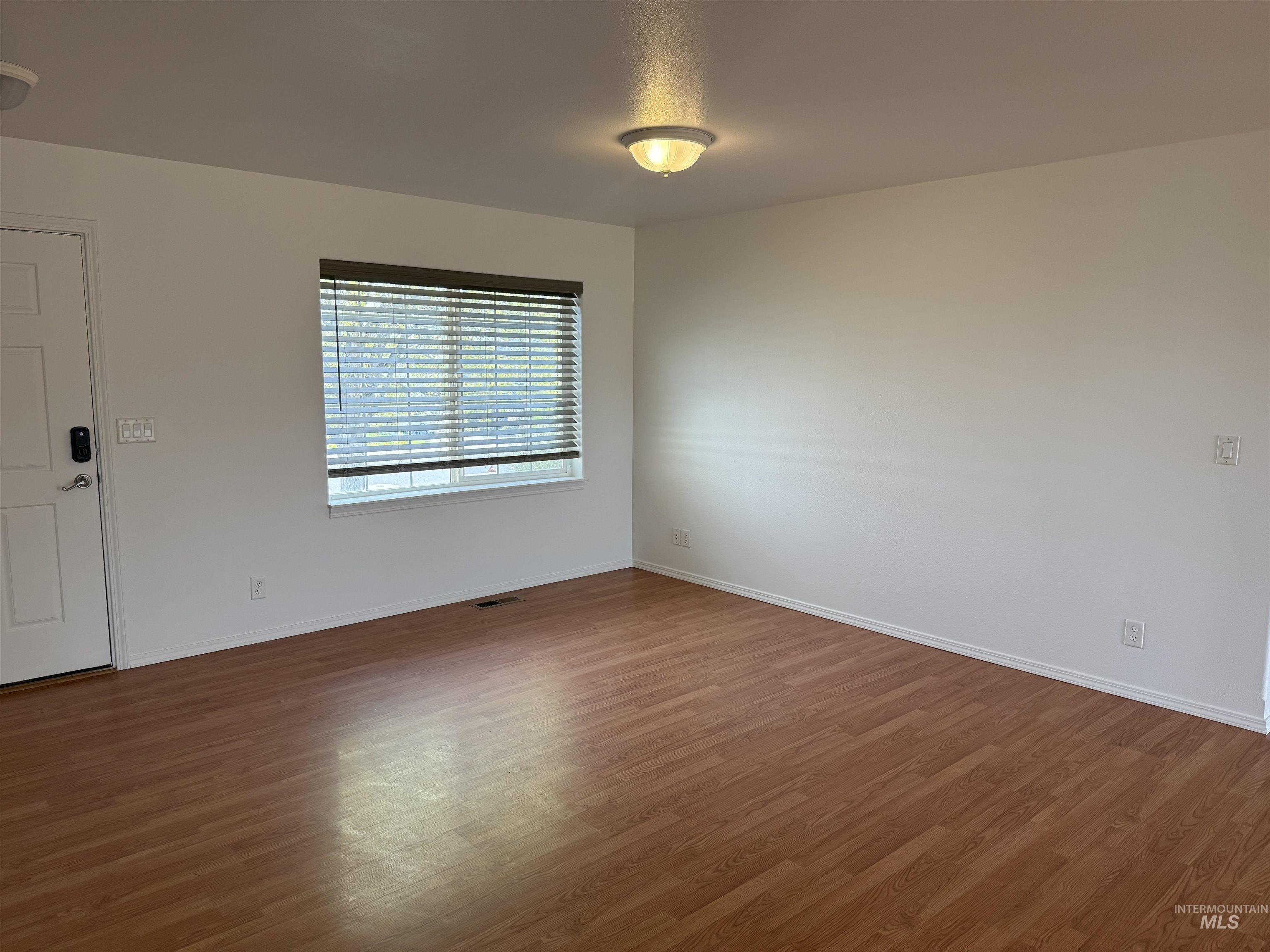 523 Morning Dove Way Marsing, ID 83639 - Photo 9 of 23 Unfurnished room featuring dark wood-style floors and baseboards