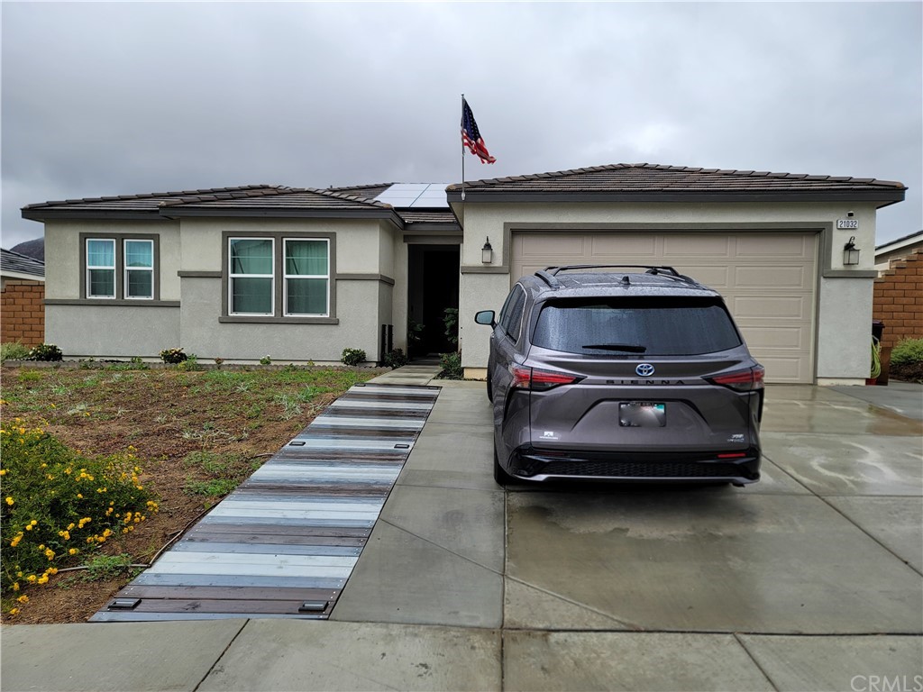 21032 Spring Mountain Road Riverside, CA 92507 - Photo 1 of 1 a car parked in front of a house