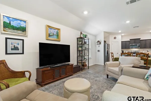 a living room with furniture and a flat screen tv