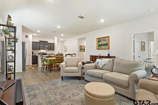 a living room with furniture and kitchen view