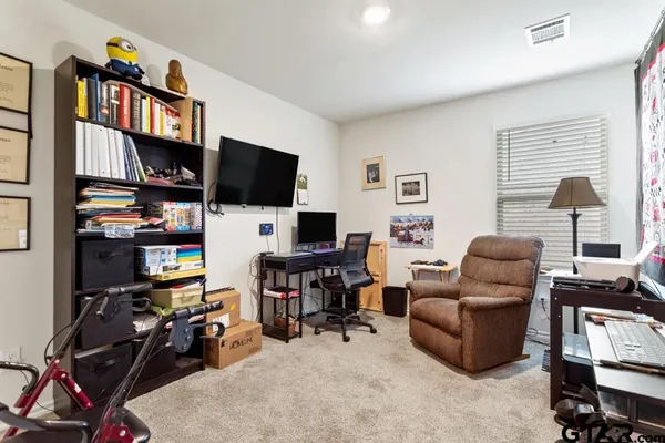 a view of a livingroom with workspace and a window