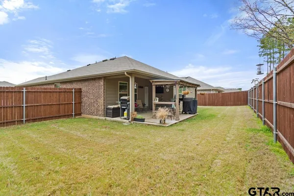 a view of a house with backyard and porch