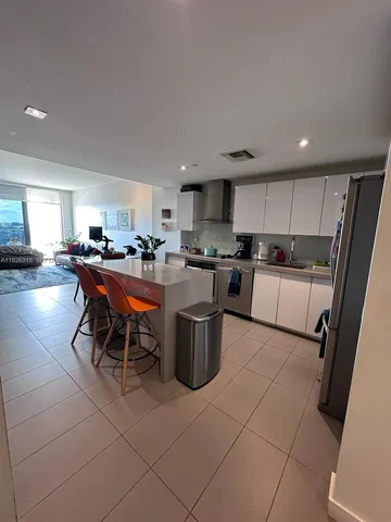 a kitchen with a sink a counter top space and appliances