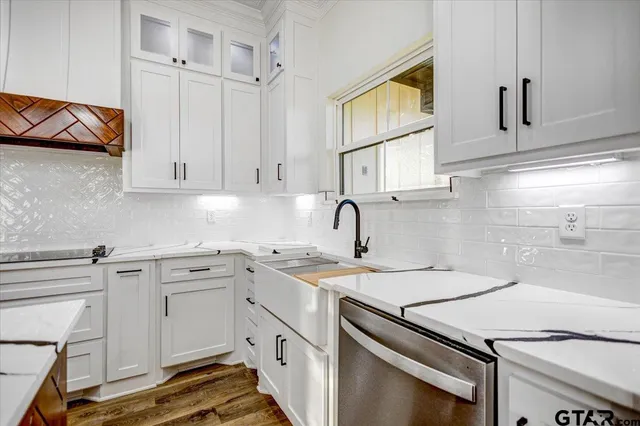 a kitchen with stainless steel appliances granite countertop a sink and cabinets
