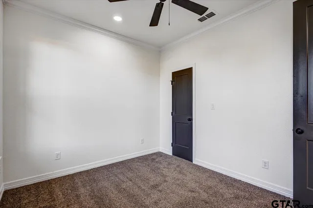 an empty room with projector and fan