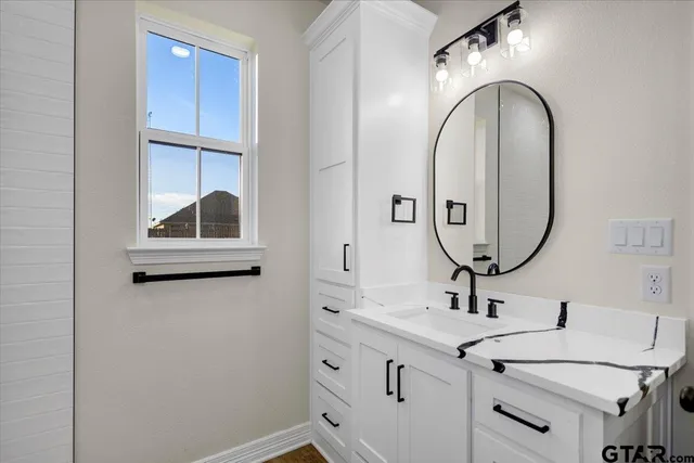 a bathroom with a double vanity sink and a mirror
