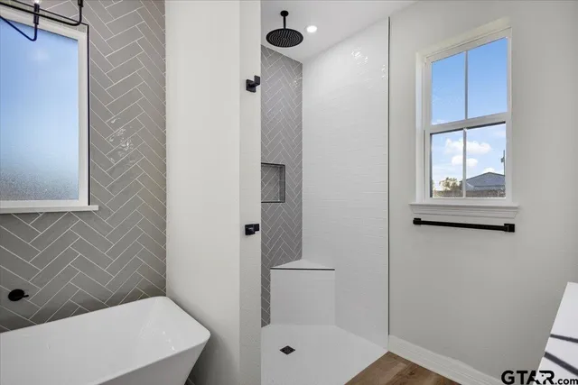 a bathroom with a toilet and a shower